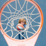 young child with basketball on playground