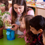 teacher shows children plants