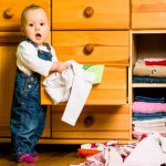 child opens dresser drawer