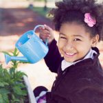young girl with watering can