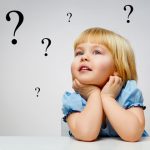 child with question marks in air around her
