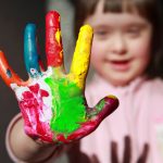 child with paint on her fingers