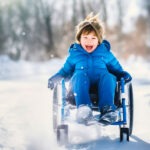 boy in wheelchair and blue, winter coat